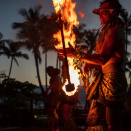 a person standing in front of a fire