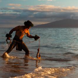 a man standing next to a body of water