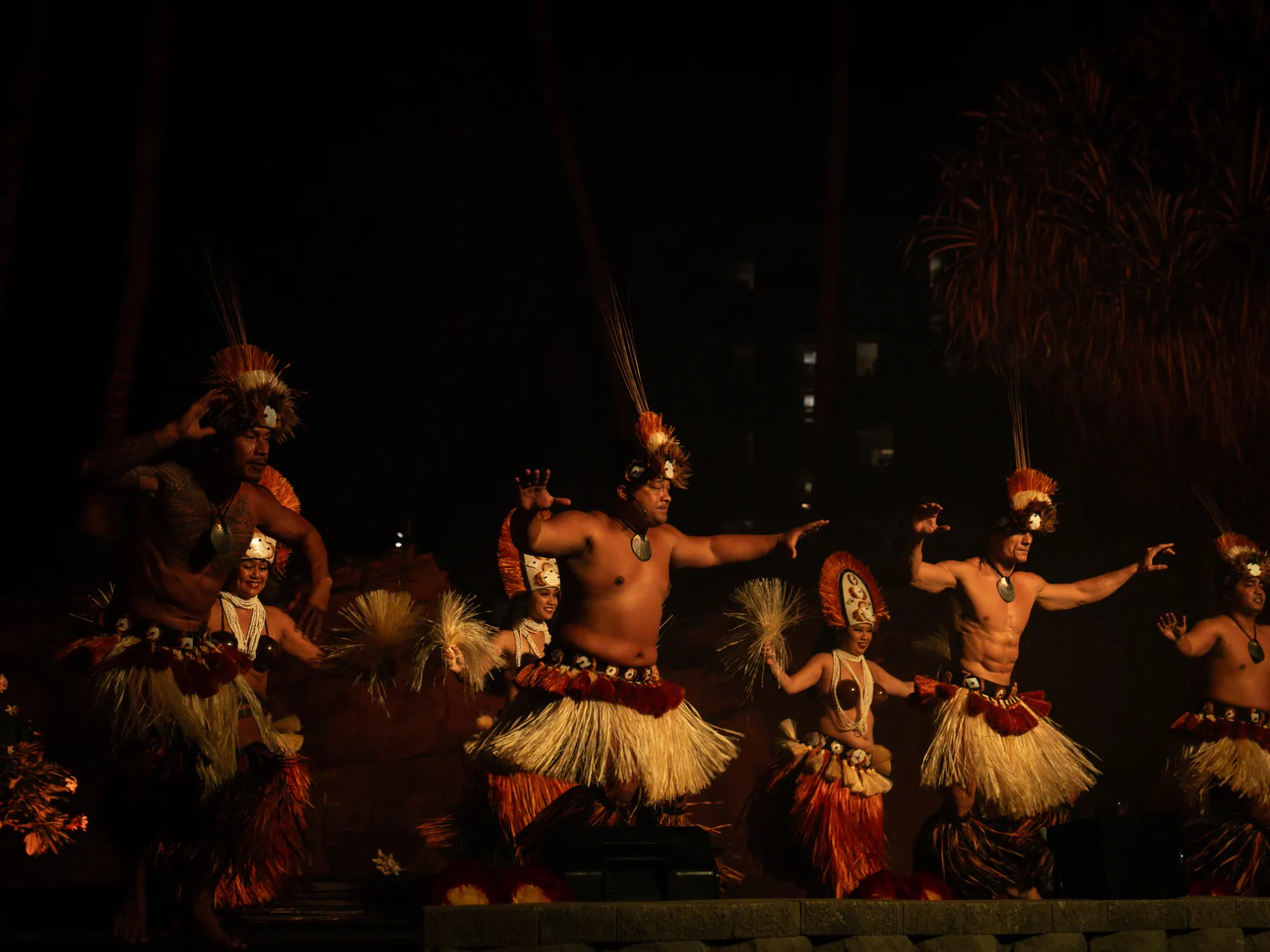 a group of people standing around a fire
