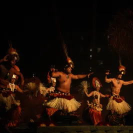 a group of people standing around a fire