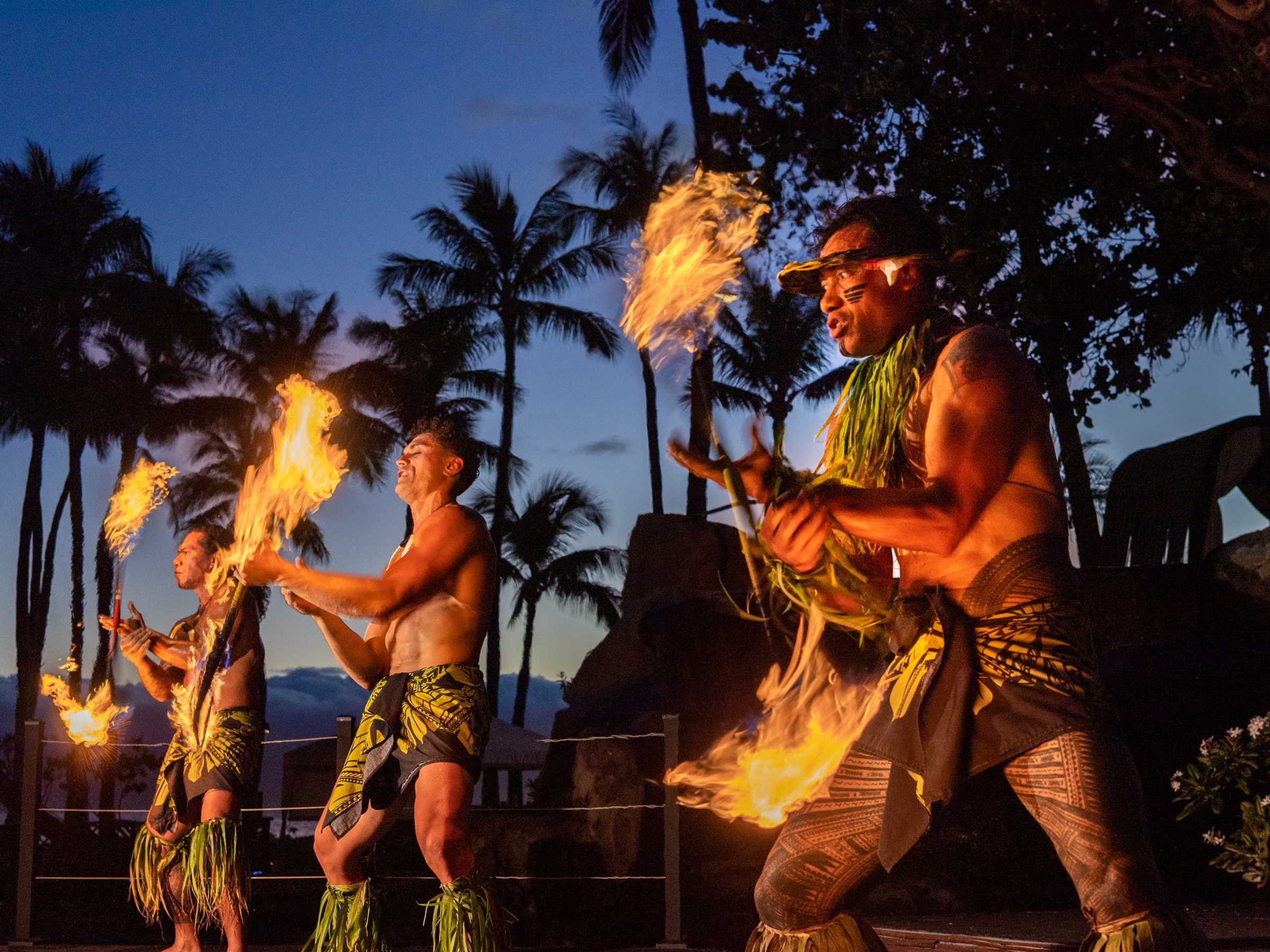 a group of people standing around a fire