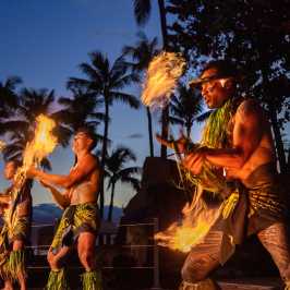 a group of people standing around a fire