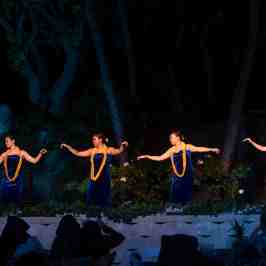 a group of people playing instruments and performing on a stage